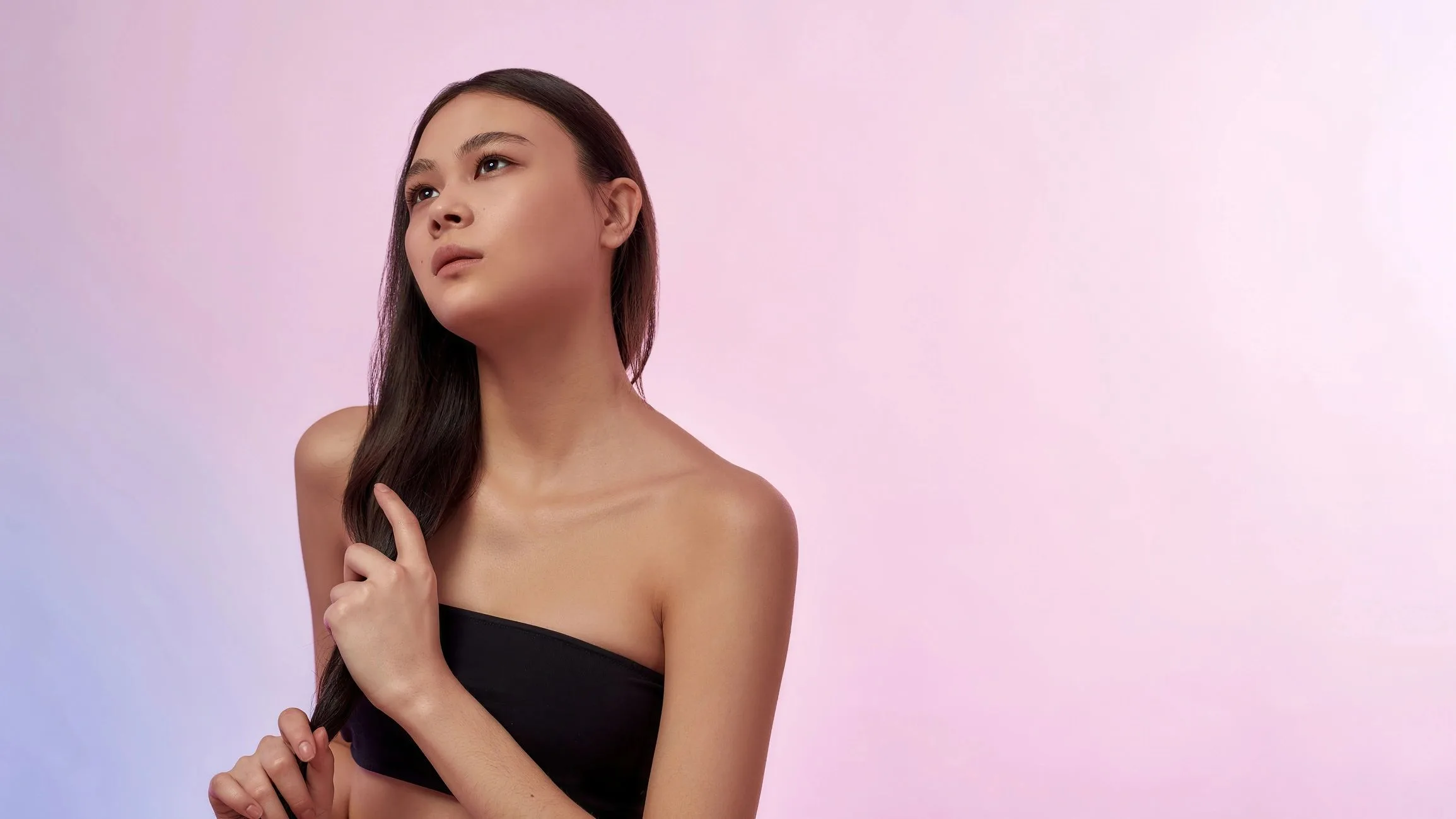 Beautiful Asian woman isolated on pink background