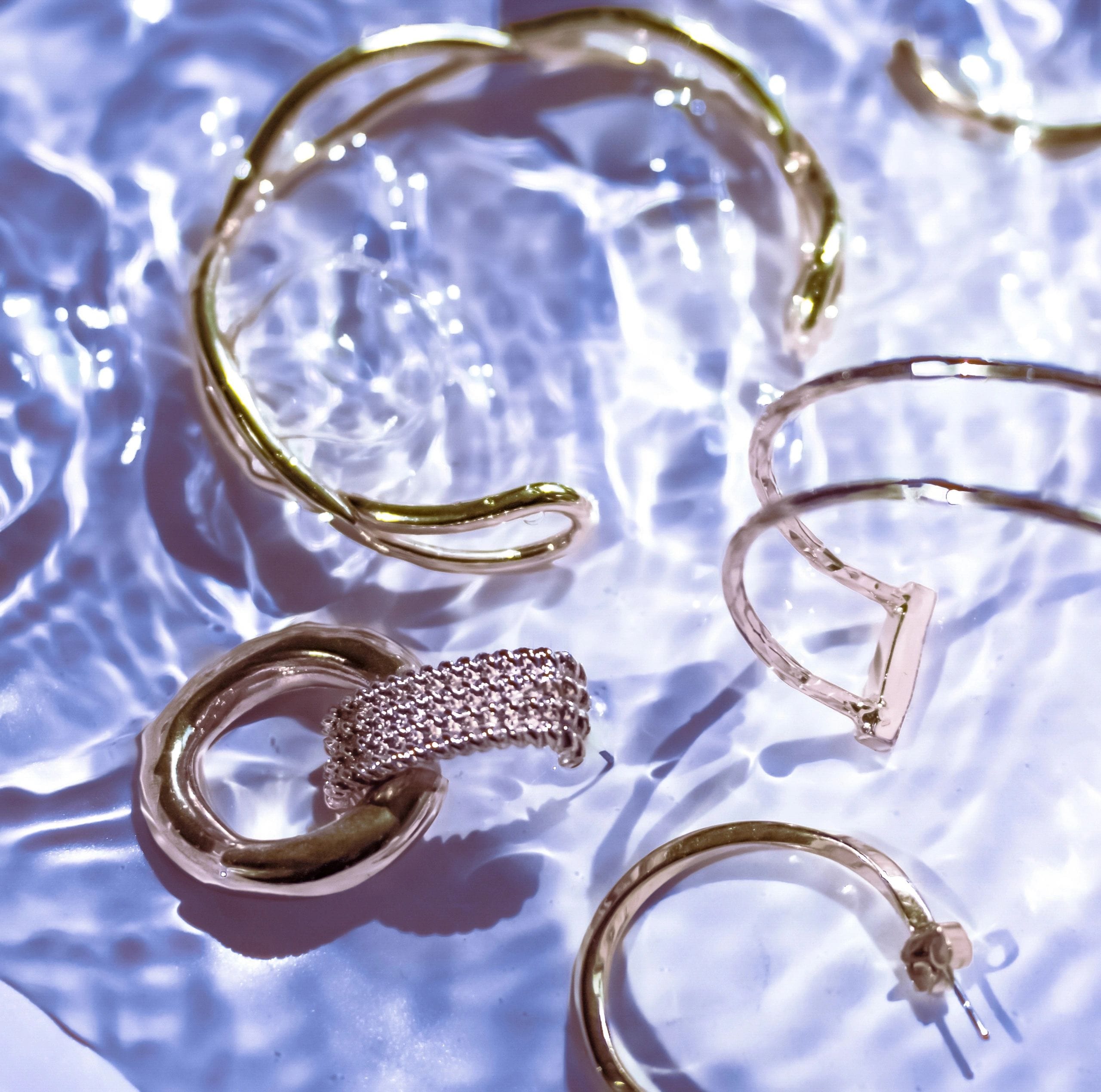 Elegant jewelry arranged in a refined flat lay